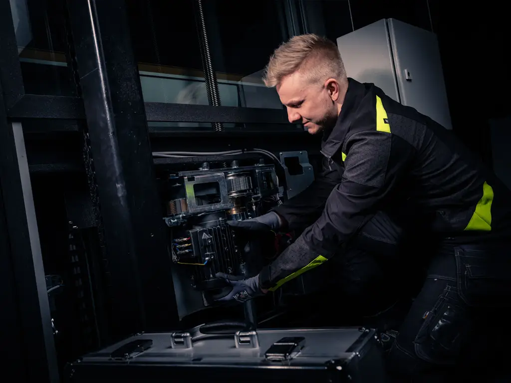 Are Home Elevators Safe? What UAE Homeowners Should Know About. 2 Cibes service technician inspecting and maintaining the screw-drive system inside a home lift.
